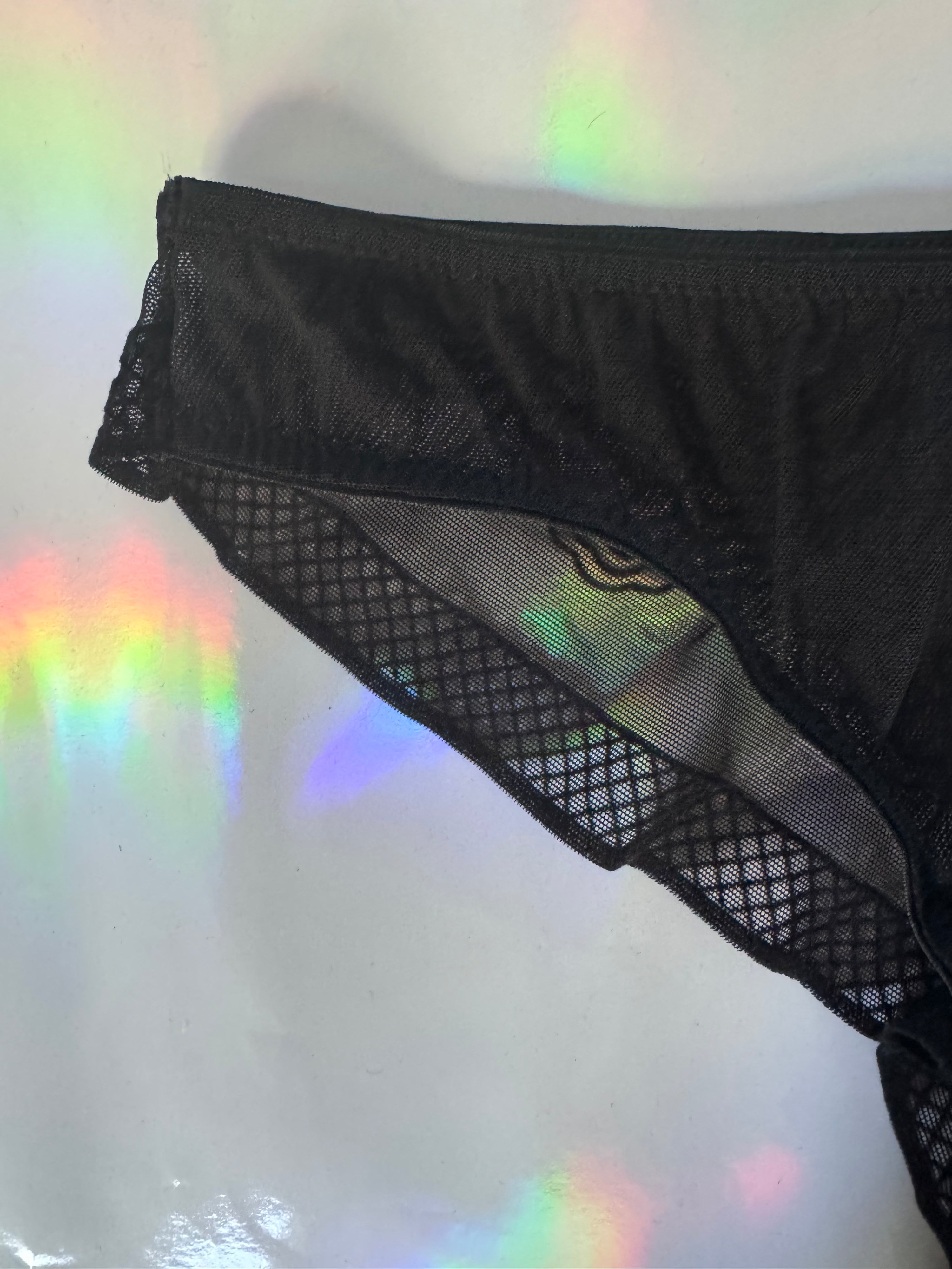 Photo of the black mesh brief with lattice criss cross edge 