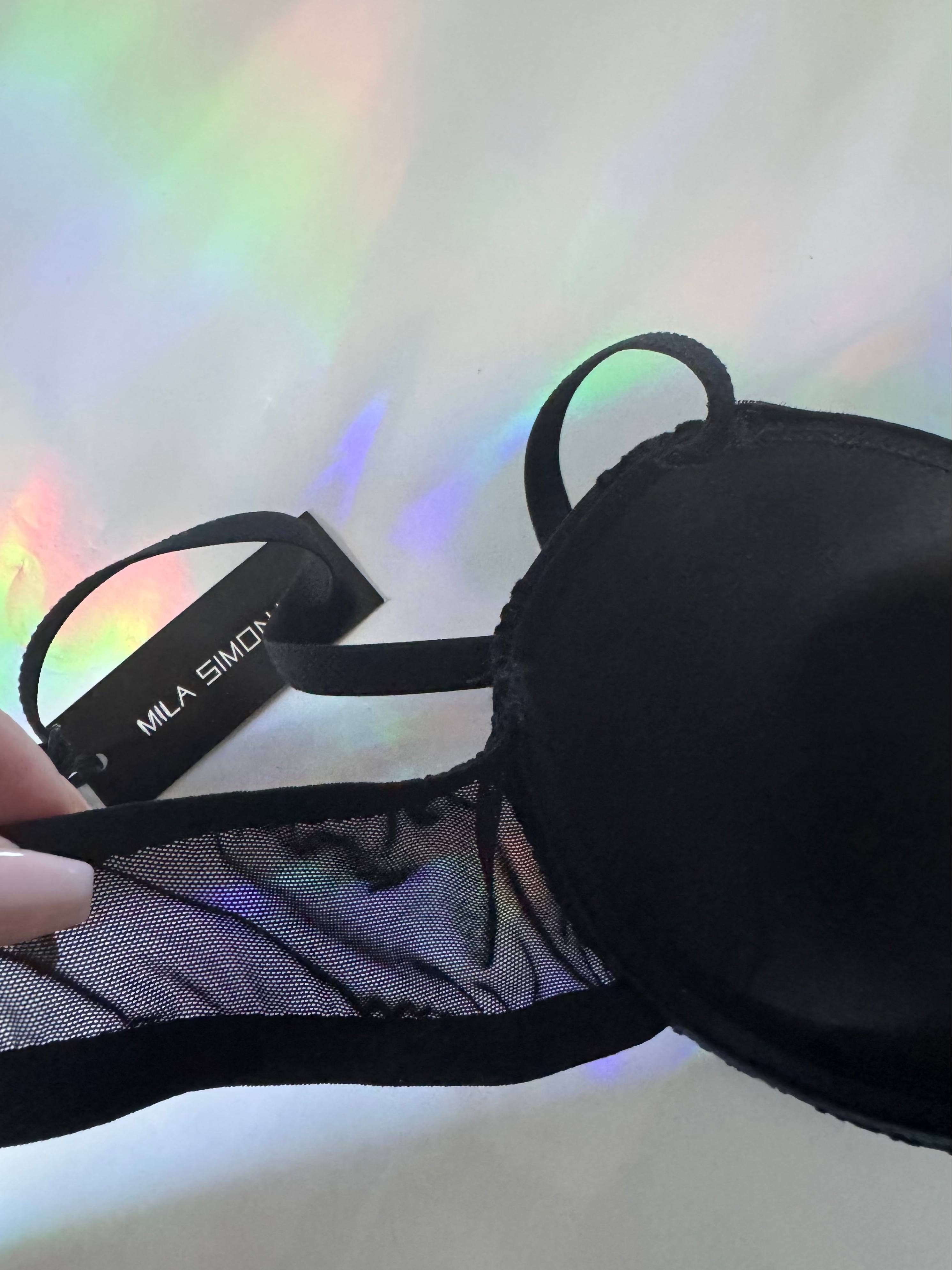Inside shot of the black mesh bra with strap and Mila Simona label 