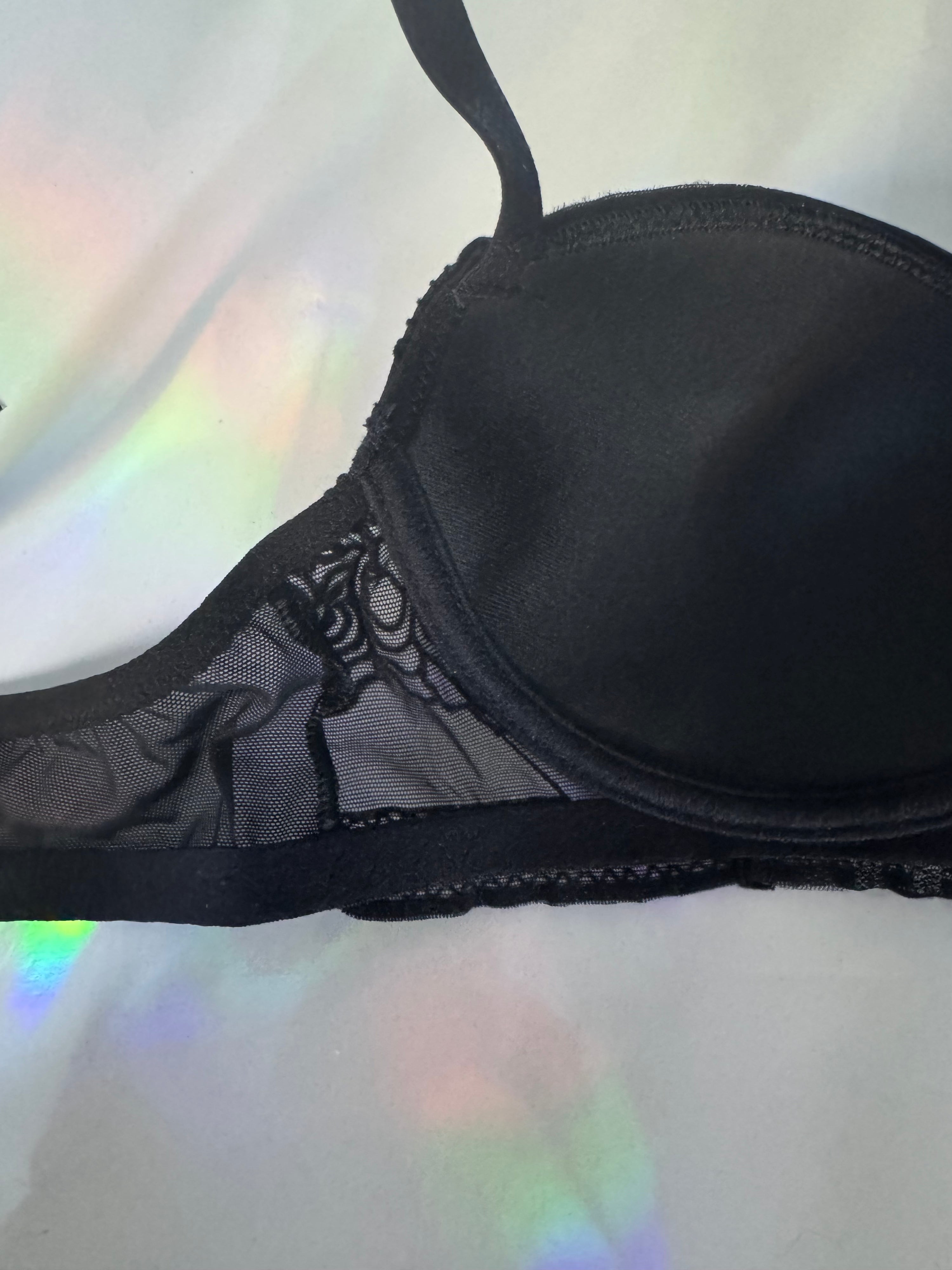 Inside shot of a black balconette bra with cups