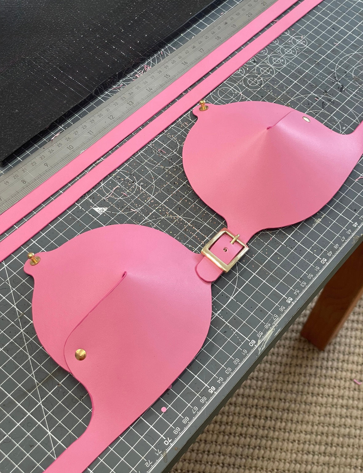 Behind the scenes of the making of a pink leather bra 